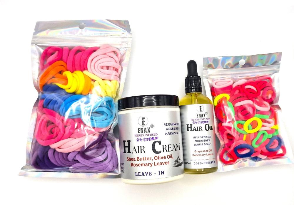 Children Care Pack3: ENAX Hair Cream, Hair Oil, Girl's Hair Ties & Toddler's Hair Ties. ENAX Girl's Hair Ties to the left, 300g jar of (ENAX) Hair Cream, 100ml bottle of (ENAX) Hair Oil in the middle. ENAX Baby & Toddler's Pink Hair Ties to the right. White background. Front side.