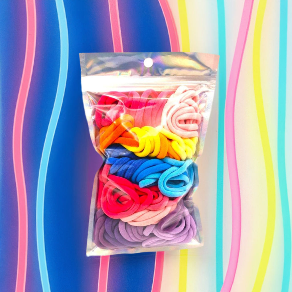Girl's Hair Ties: ENAX Multi-Coloured Hair Bands, One silver pack of (ENAX) colorful medium-sized Hair Ties. 80 hair ties inside each pack. Neon Stripy colourful background. Front Side.