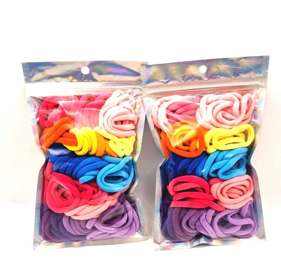 Girls' Hair Ties Pack of 2: ENAX Multi-Coloured Girls Hair Bands, Two silver packet of (ENAX) colorful medium-sized Hair Ties. 80 hair ties inside each pack, two packets in picture. White background. Front Side.